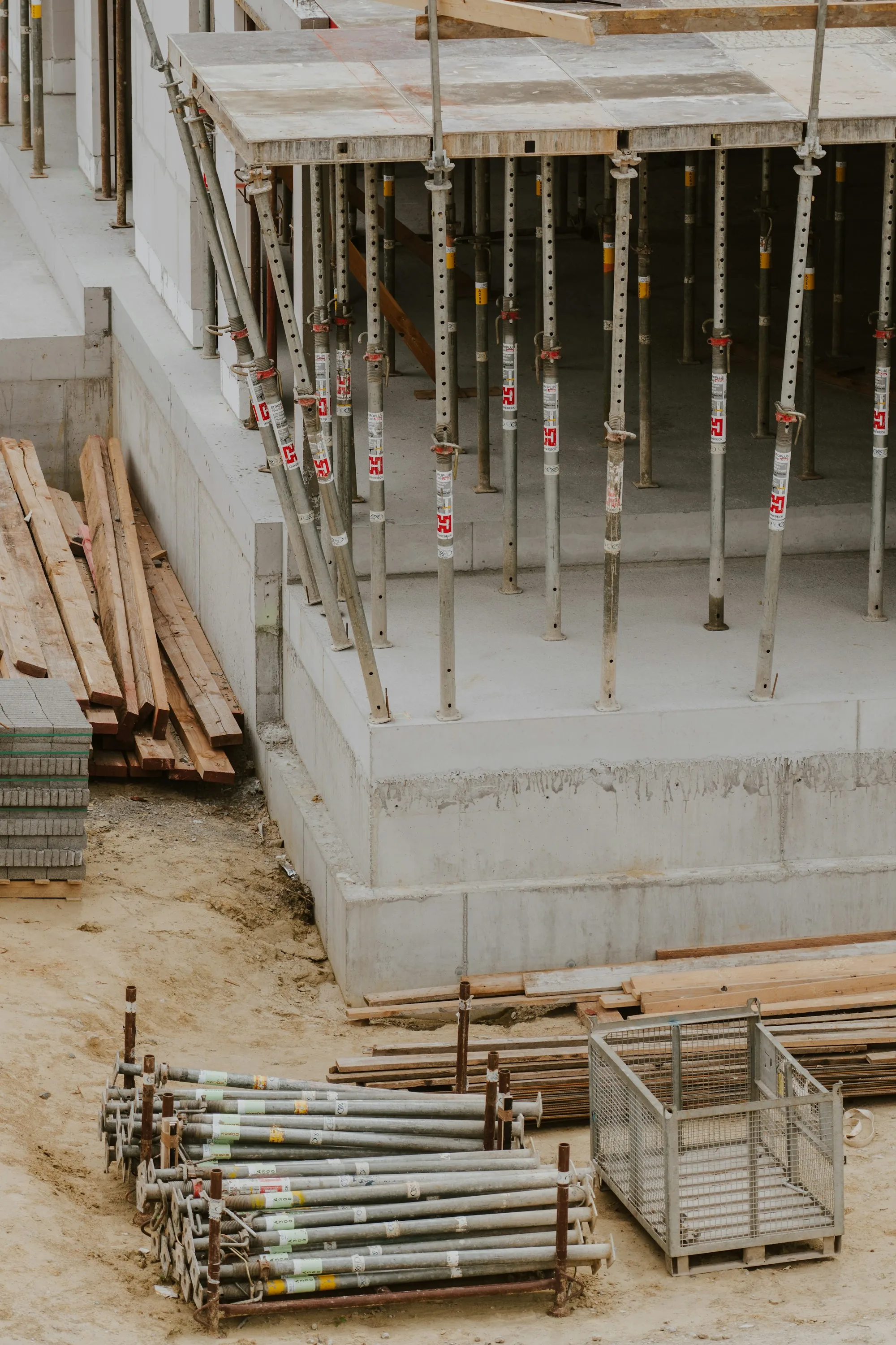 Concrete footing beside lumber and rebar